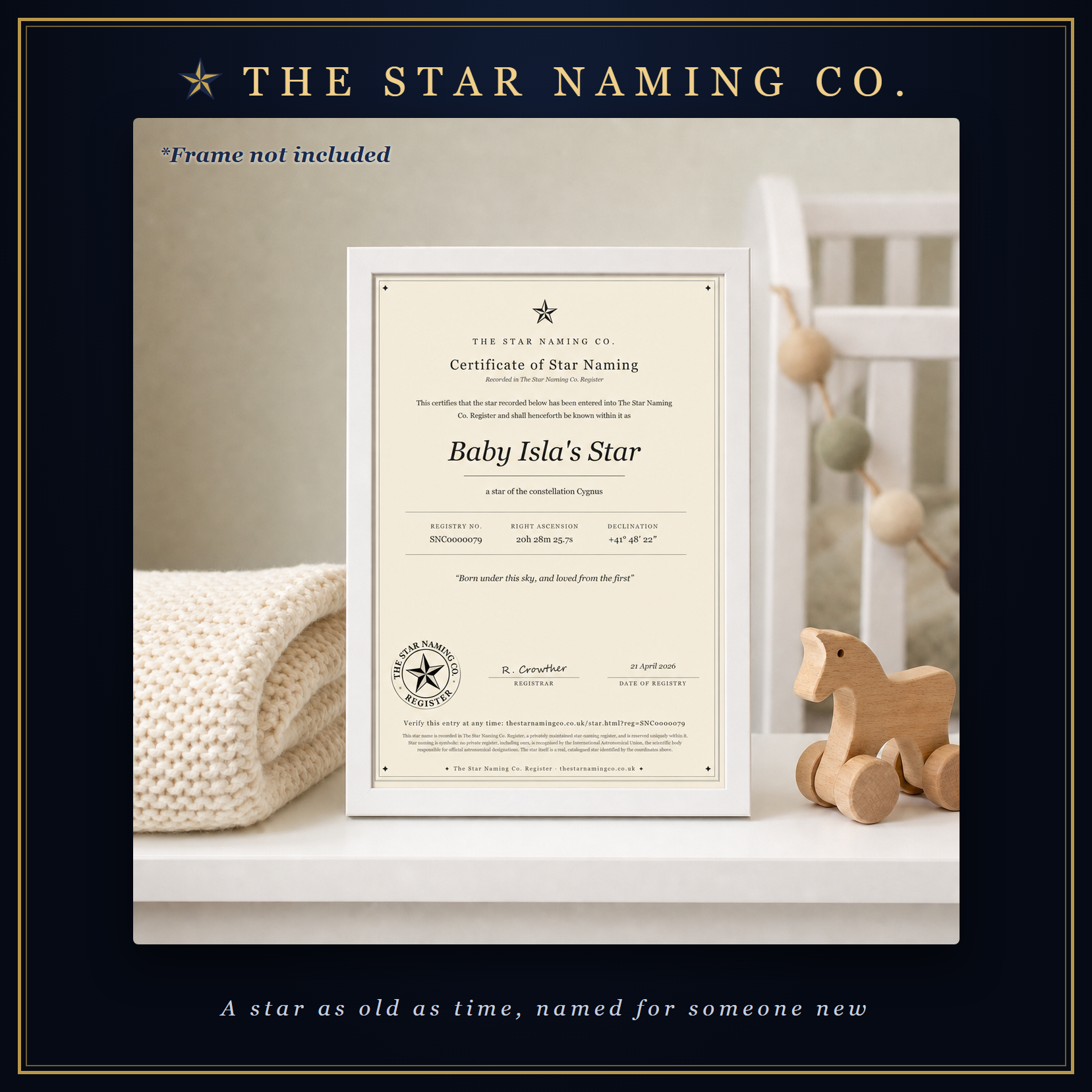 A framed Certificate of Star Naming for Baby Isla&rsquo;s Star on a nursery shelf beside a knitted blanket and a wooden toy horse, in The Star Naming Co. frame.